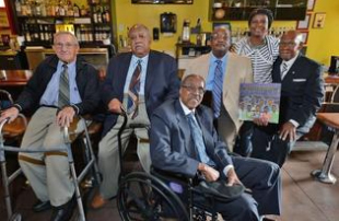 Civil rights activist David Boone, left, who took part in 1960s sit-ins, and Friendship Nine members Clarence Graham, James Wells, Willie McCleod, and W.T. “Dub” Massey, meet with author Kimberly Johnson, second from right, at the former McCrory’s store, now the Five and Dine restaurant, in downtown Rock Hill.