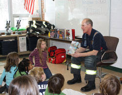 Tim Hoppey, author of The Good Fire Helmet, reads to children in schools.