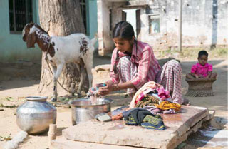 A woman washes clothes in rural India.