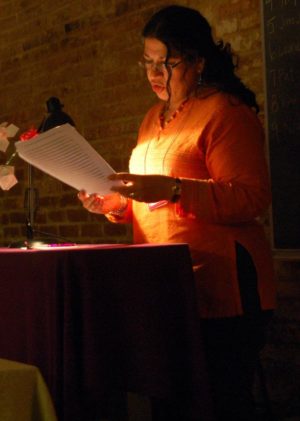 A participant in the Iowa Summer Writing Festival reads her manuscript aloud.