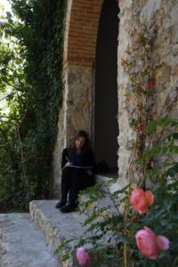 Karen writes longhand in a beautiful spot on the side of an old chapel on the villa grounds.