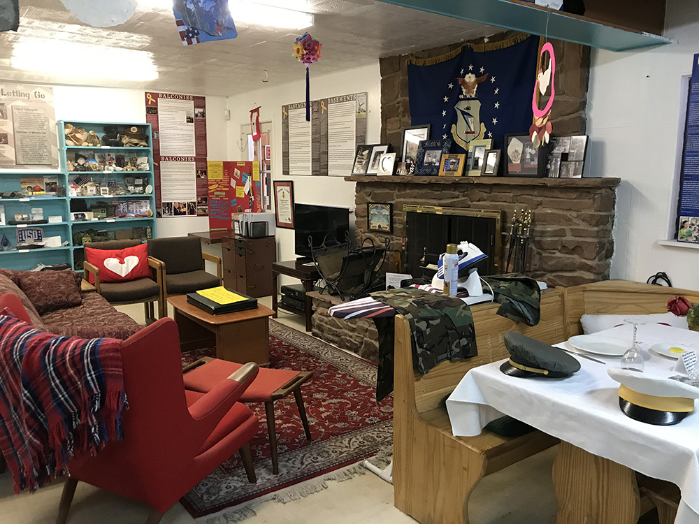 The Museum's "Together We Serve" exhibit includes living and kitchen areas representing military family homes with artifacts from many eras. More panels with quotes from military spouses are displayed on the walls. 