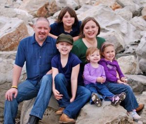 Chad Barrett (left), and his wife Melissa in 2010 with their children, Kristina (center), Jonathan (top), Katherine, and Caroline (bottom right).
