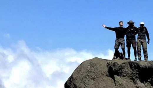 Joel Neeb, coauthor of Survivor’s Obligation, climbing Mount Kilimanjaro in Tanzania, with a group of fellow survivors.